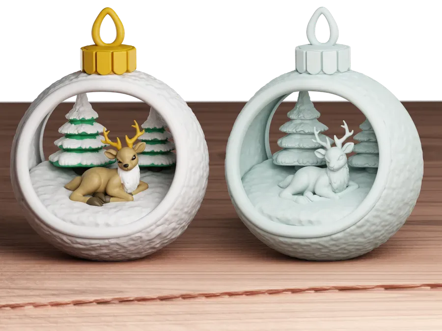 Deux boules de Noël ouvertes avec un cerf et des sapins à l'intérieur